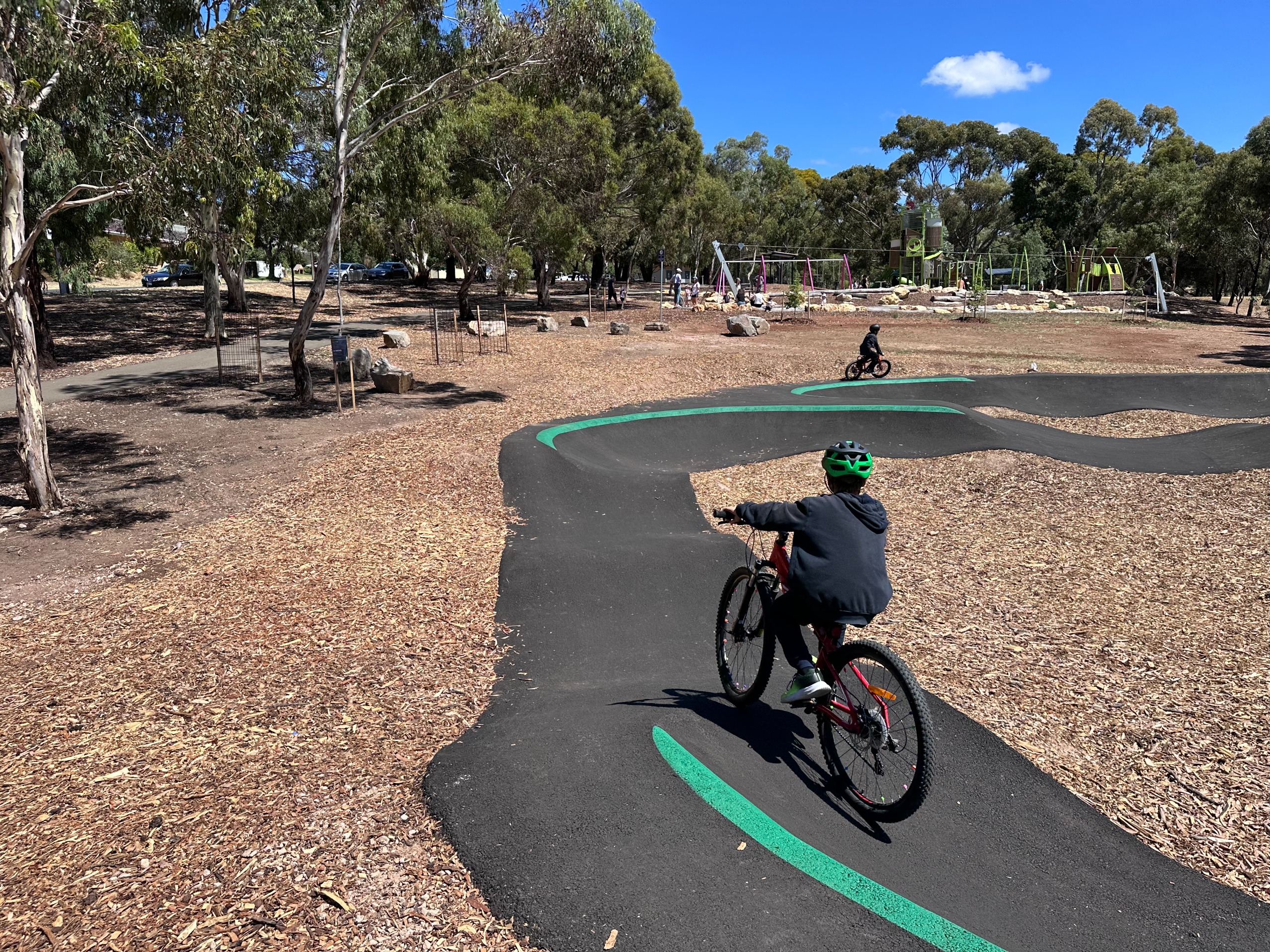 Young riders using the pump track at CC Hood Reserve